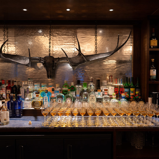 Bar at Corrigan's Mayfair complete with glasses on wine