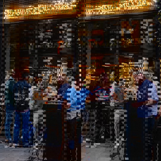 People drinking outside of Daffodil Mulligan restaurant in Shoreditch, London